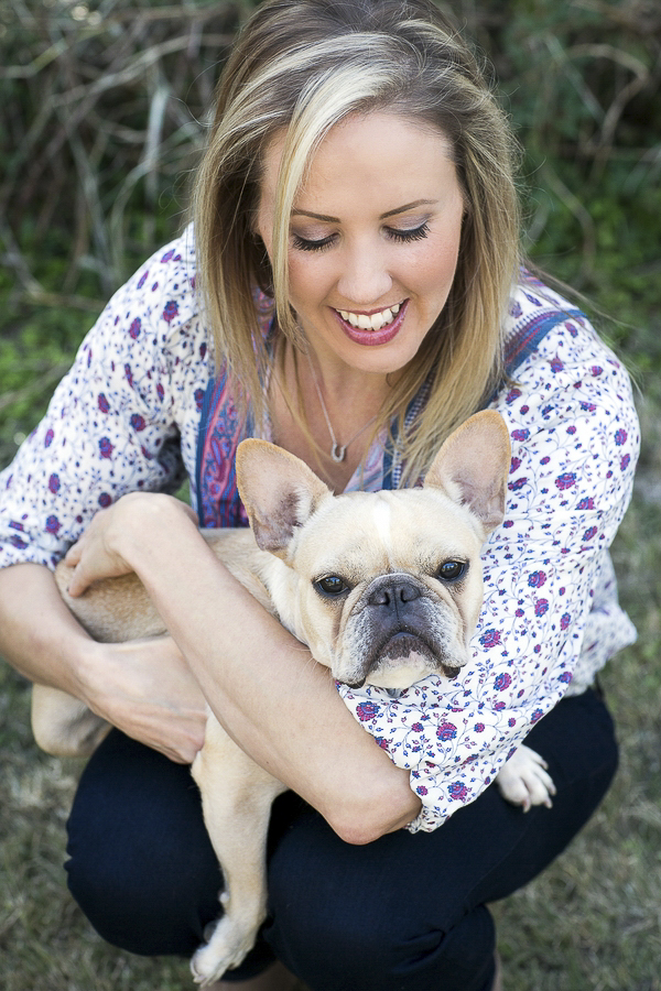 woman holding adopted Frenchie, people pet connection