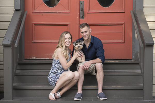 Engaged couple, small puppy, orange doors, Havashire puppy, Havanese-Yorkshire Terrier mix