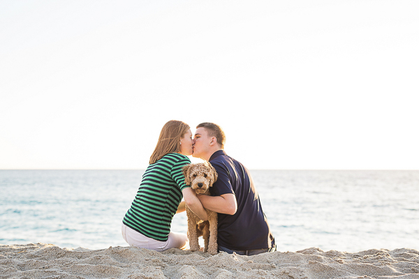 Golden Doodle puppy beach, couple holding puppy and kissing on the beach ©Joey Photos