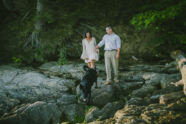 couple and dogs walking on rocks