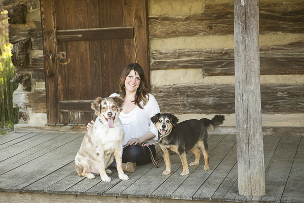 rescue dogs, Scout and Chloe, with person on cabin porch