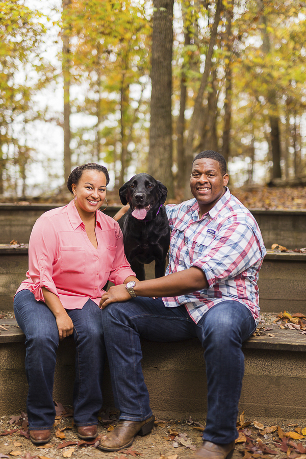 autumn engagement-session-with-dog, couple sitting on bench, dog between them