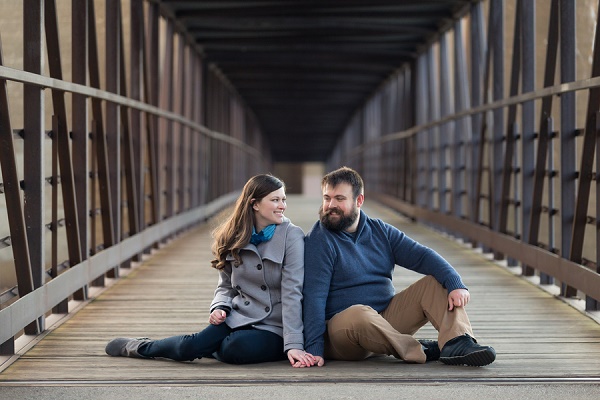 couple sitting on bridge