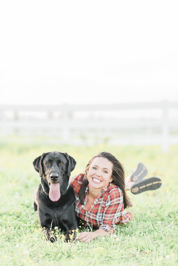 black lab and woman in plaid shirt lying in field, dog-human bond, 