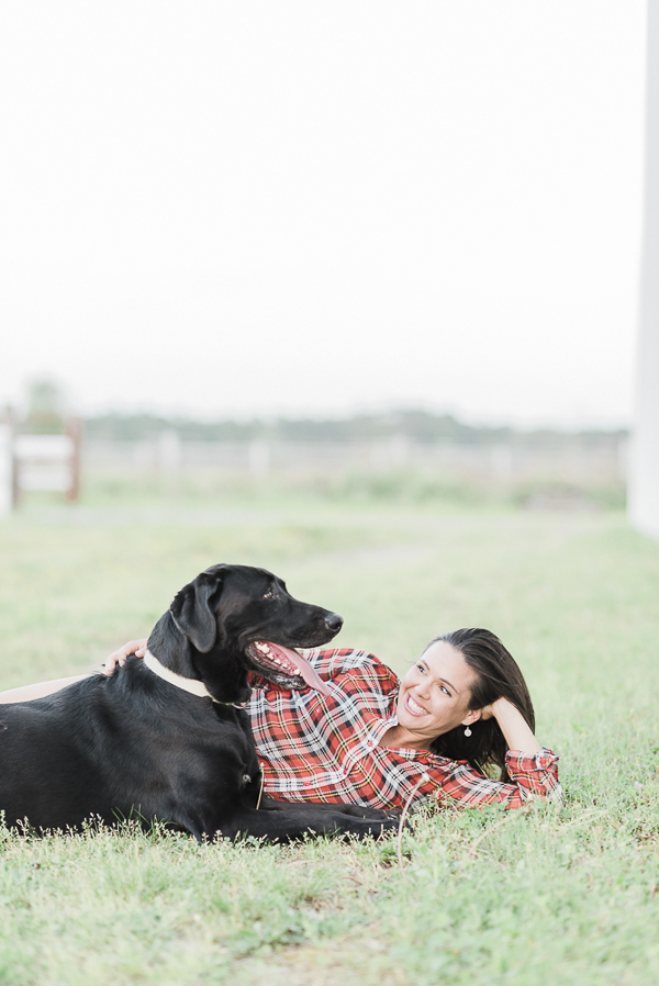 woman lying on side looking at her dog, love between humans and dogs