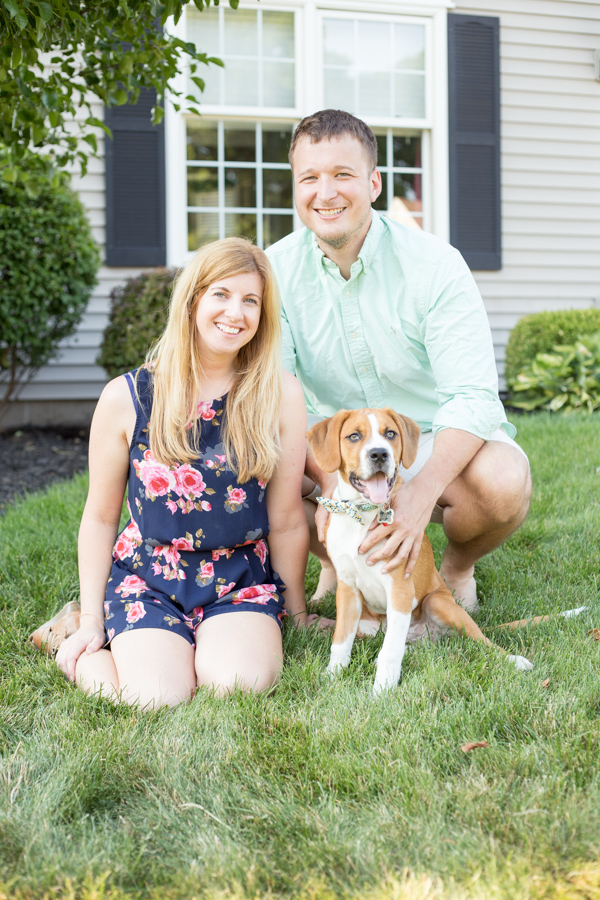 family portrait with dog in front yard