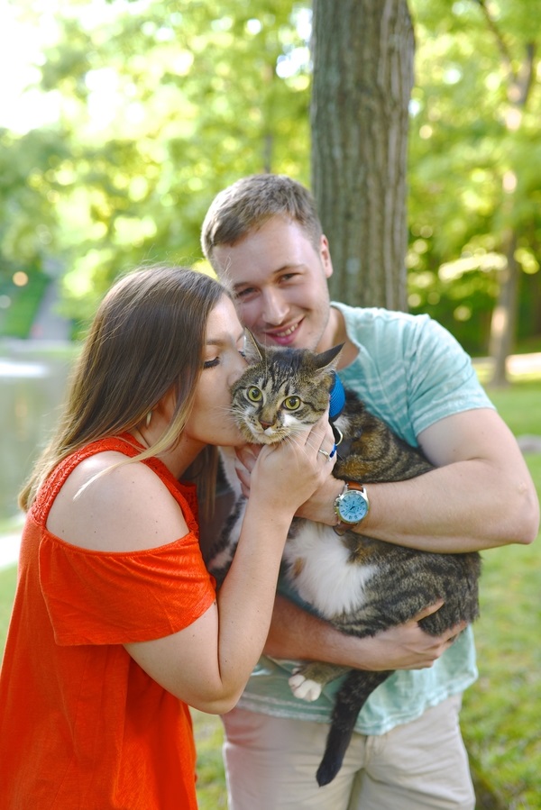 woman kissing tabby cat, engagement photos with cats