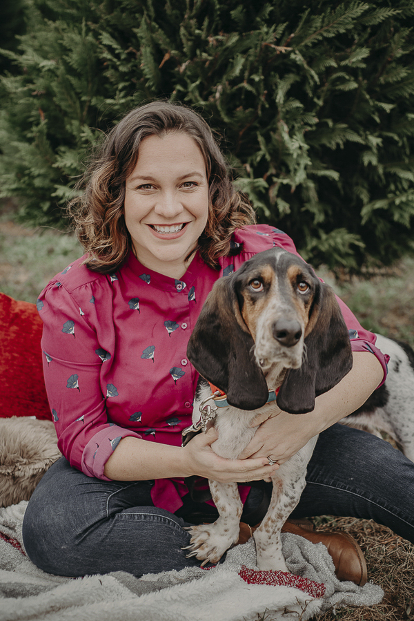 woman and her Basset Hound at Christmas tree farm