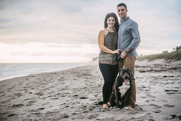 couple and dog standing on the beach, Husky-Shepherd mix on beach, engagement photos with dogs