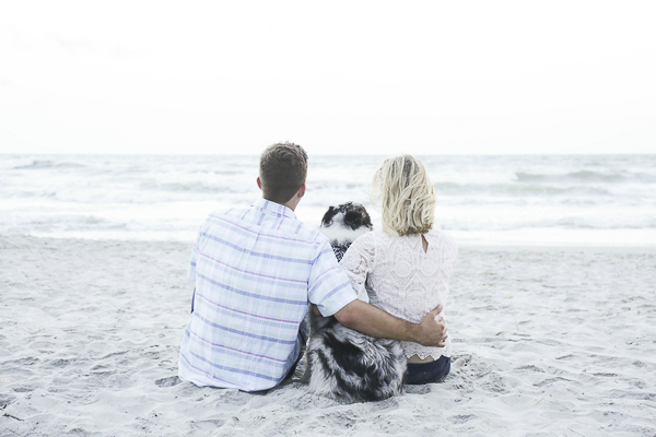 couple on sandy beach with dog, romantic SC beach engagement photos