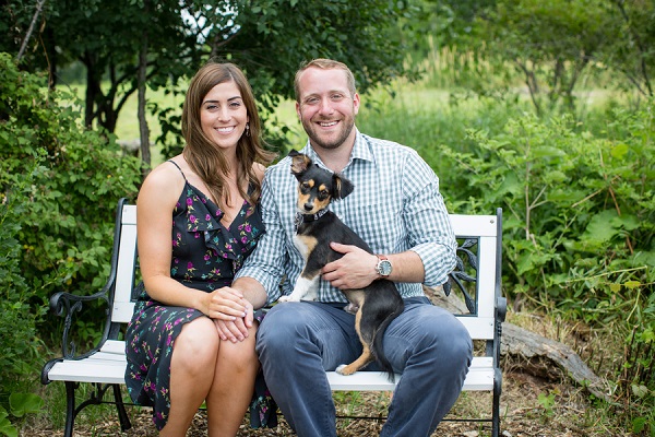 couple sitting on bench at Hops farm with puppy. ideas for dogs in engagement pictures