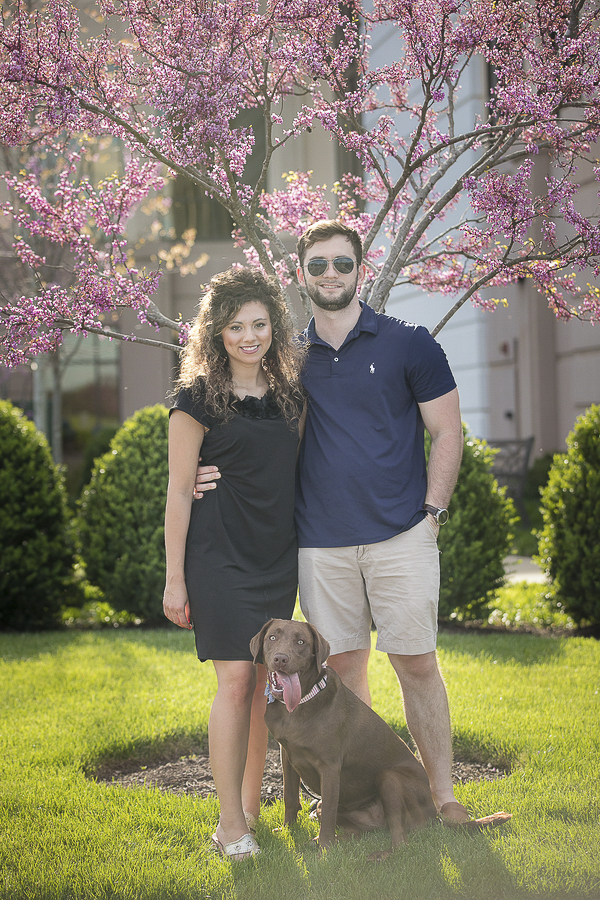 couple and their dog in front of flowering tree, lifestyle pet portraits, ©K Schulz Photography 