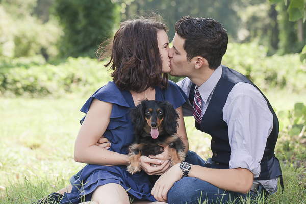 couple kissing with dog on their lap, ©Casey Hendrickson Photography, engagement photos with Doxie
