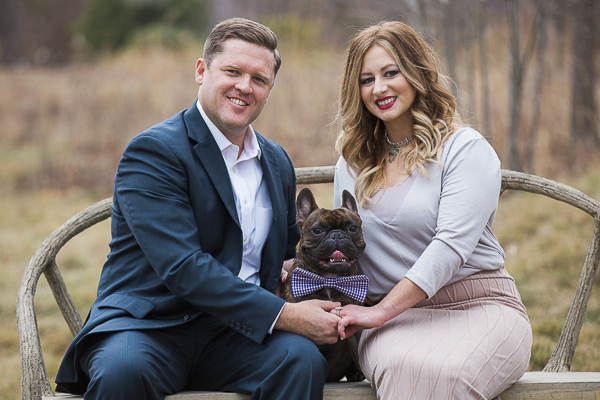 couple sitting on bentwood bench with Frenchie, ©Meghan Rolfe Photography | Asheville Engagement photos with French Bulldog