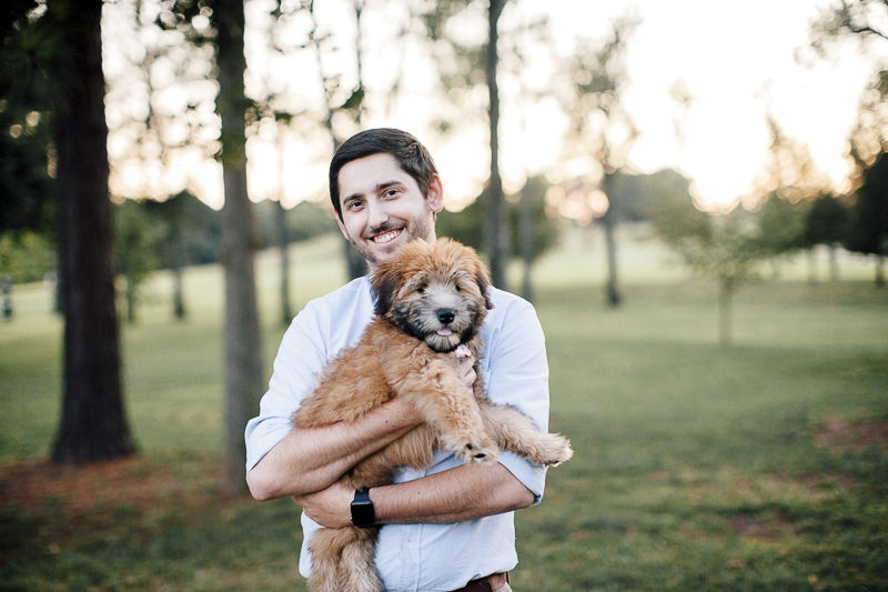 man holding adorable Wheaten Terrier puppy, fluffy dog