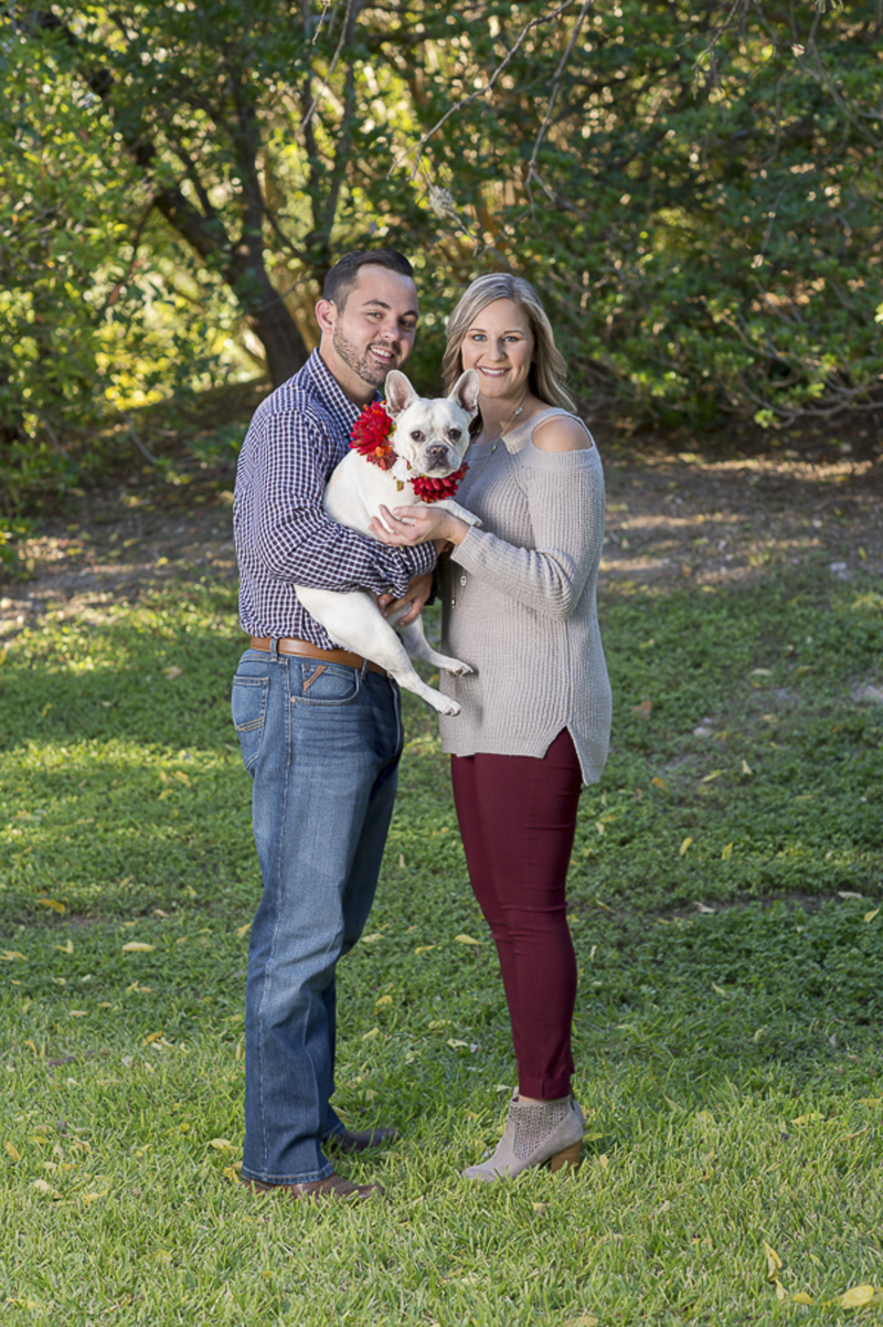 couple holding white French Bulldog, ©Ata-Girl Photography | San Antonio engagement photos with dog