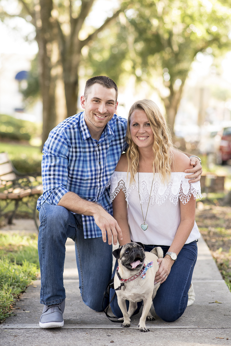 couple on sidewalk with Pug, engagement pictures with dog, ©Corner House Photography | Mount Dora dog friendly engagement session