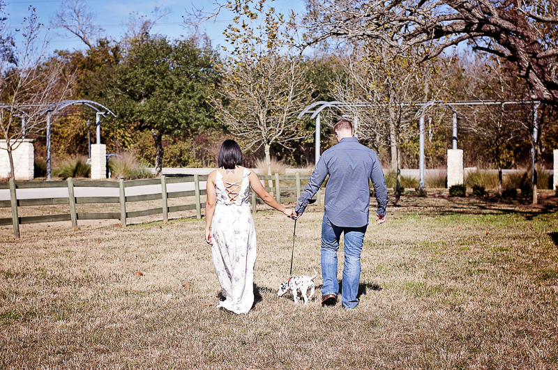 couple walking their puppy | ©Kelly Urban Photography | dog friendly engagement photos, Richmond, Texas