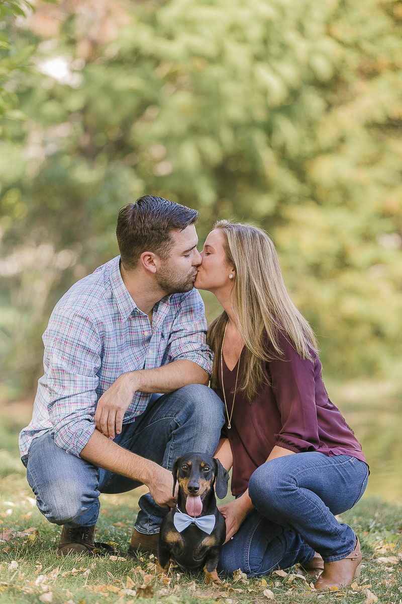 couple kneeling on ground kissing each other with Doxie in front of them, ©Jamie Bodo Photography | New Brunswick, NJ, dog-friendly engagement photos