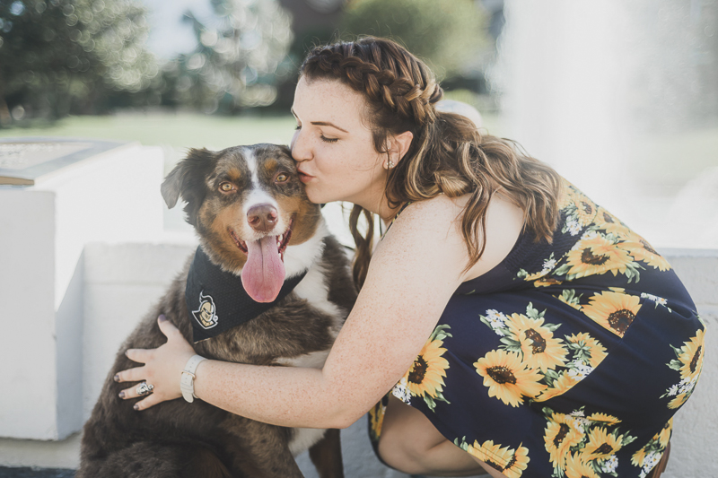 young woman kissing Australian Shepherd, University Central Florida Graduation, ©Haleigh Nichole Photography