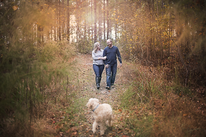 couple walking through the woods with their dogs, fall family photos ©Alicia Hite Photography 