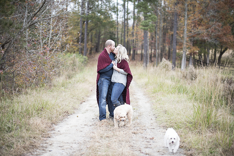 fall/winter family photo ideas, couple wrapped in blanket and their dogs on dirt road, ©Alicia Hite Photography | NC family photography, dog-friendly photographer,