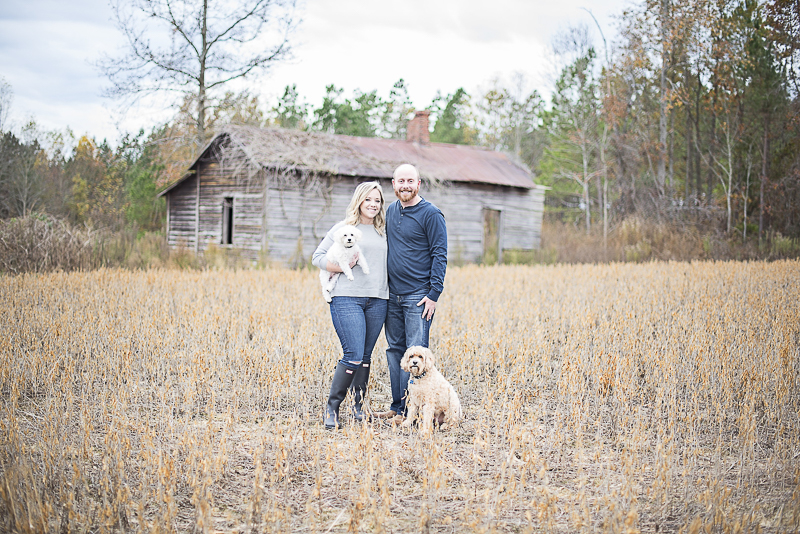 couple and their dogs in front of old farm building, lifestyle dog photography | ©Alicia Hite Photography