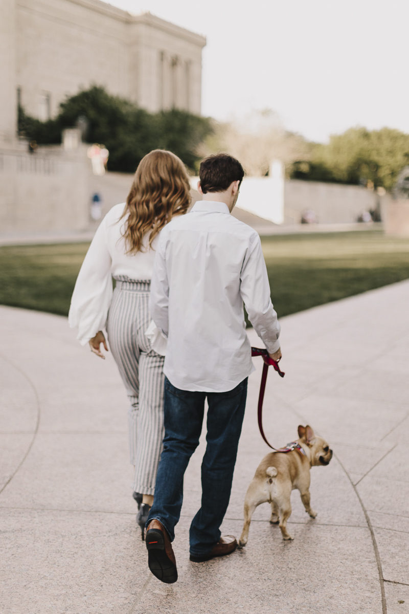 couple walking their Frenchie, ©Alyssa Barletter Photography | Kansas City Engagement Photos with a dog