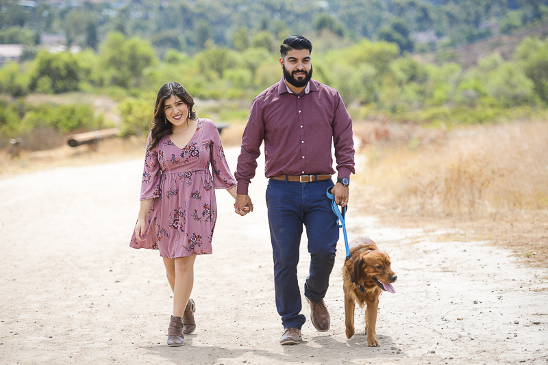 engaged couple walking their dog along trail, ©CR Photography | Santee, CA dog-friendly engagement session