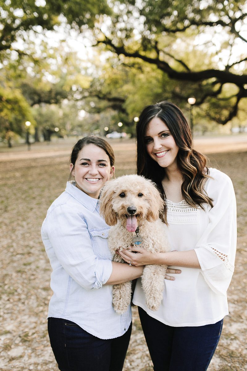 couple holding their goldendoodle, out door engagement photos with a dog, same sex engagement photos, New Orleans, ©Theresa Elizabeth Photography 