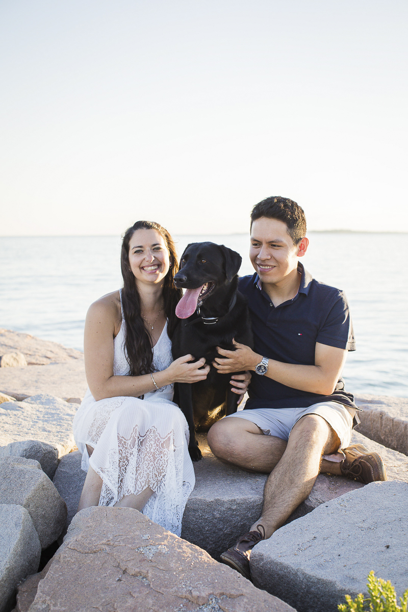 couple sitting on rocks with Lab between them, dog-friendly engagement photoshoot, ©Trish Kemp Photography