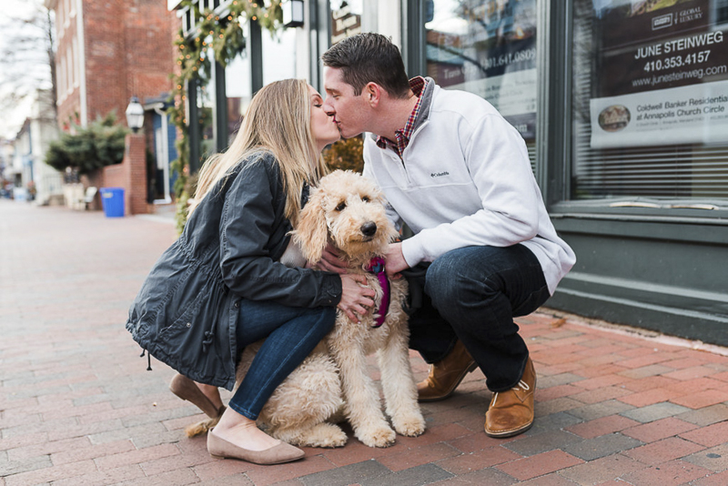 couple kissing over their dog, ©Ashton Kelly Photography | engagement session with a dog, Annapolis, MD