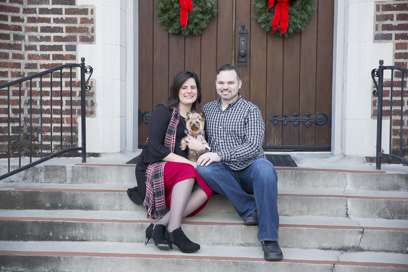 couple and their dog sitting on church steps, holiday photos with a Yorkie