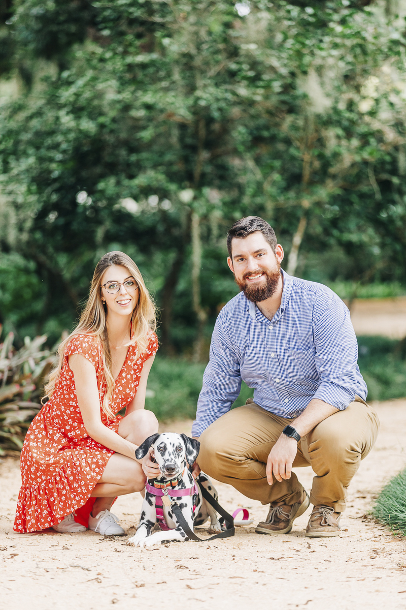 Dalmatian lying between her people, ©Kenzie Rae Photography | engagement photos with a dog, Washington Oaks State Park, Florida