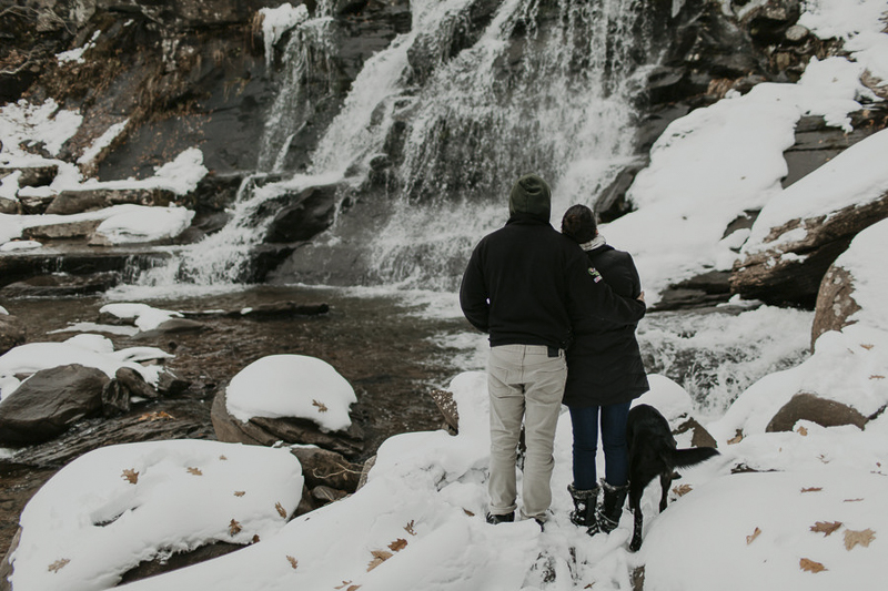 couple and their dog looking at waterfall, winter wonderland, ©Belle La Vie Images | Hudson Valley dog friendly engagement pictures