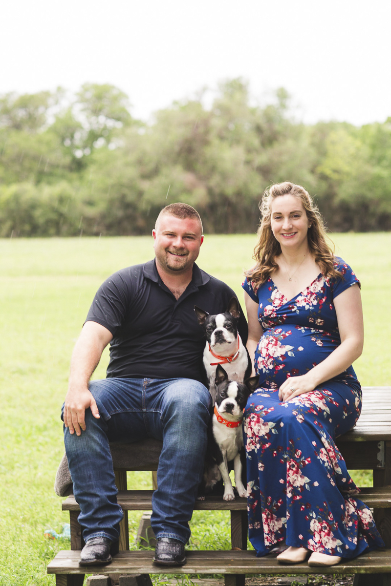 couple sitting with their dogs on picnic table, ©Amber Elaine Photography- maternity photos with dogs