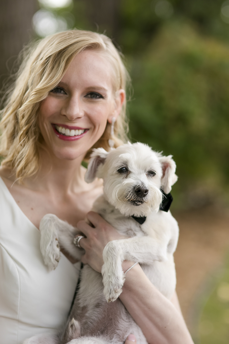 bride holding her cute rescue dog, little white dog, wedding photos with dogs | ©Jeannine Marie Photography 