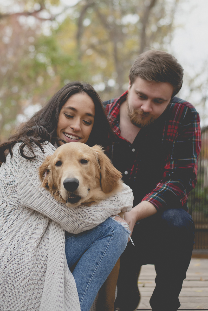 engaged couple looking lovingly at their Golden Retriever puppy | ©Tammy Klepac Photography 