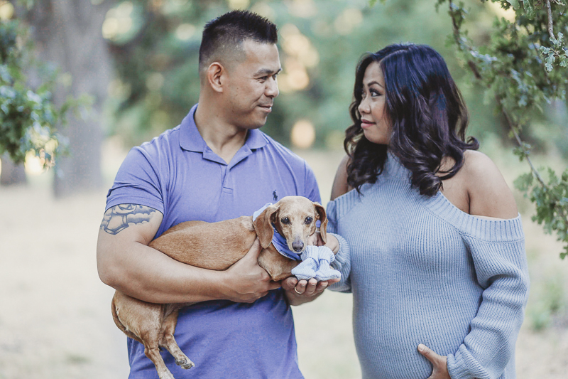 couple looking at each other, man holding Doxie, ©Kathy Izzy Photography, Sacramento and Bay Area maternity photography