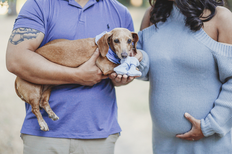 couple holding dachshund and baby socks, maternity photos ideas ©Kathy Izzy Photography