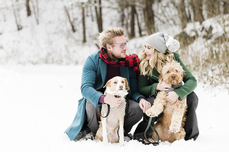 outside family portraits with dogs in the snow, winter photography ideas, cute doodle dog wearing blue sweater, ©Lauren Engfer Photography