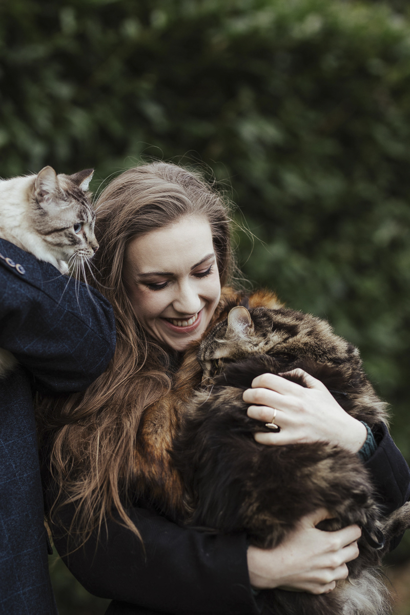 Maine Coon snuggling with woman outside, Ragdoll looking out, ©Olga Hogan Photography | engagement photos with cats