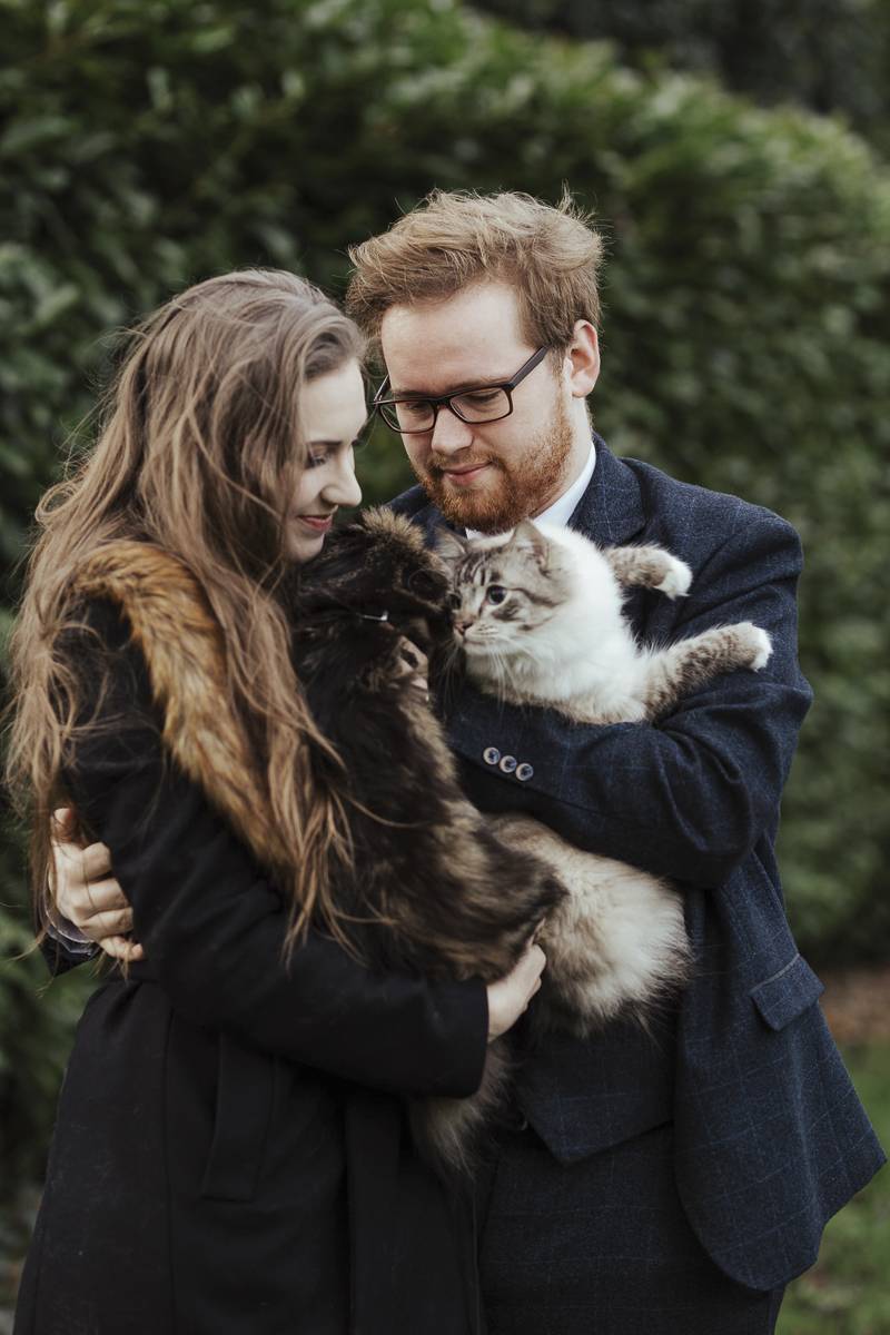 engaged couple holding their cats, ©Olga Hogan Photography | engagement photos with cats