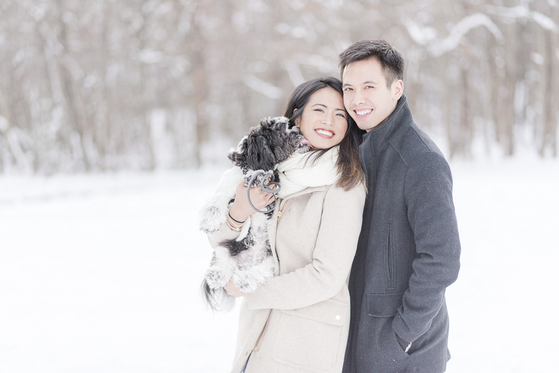cute small dog licking woman's face, snowy engagement photos | ©Rebecca Sigety Photography