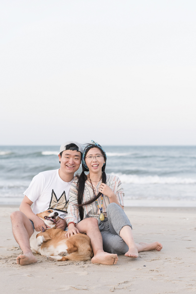 ©Michelle and Sara Photography, cute couple and their Corgi at the beach, dog-friendly engagement photo ideas