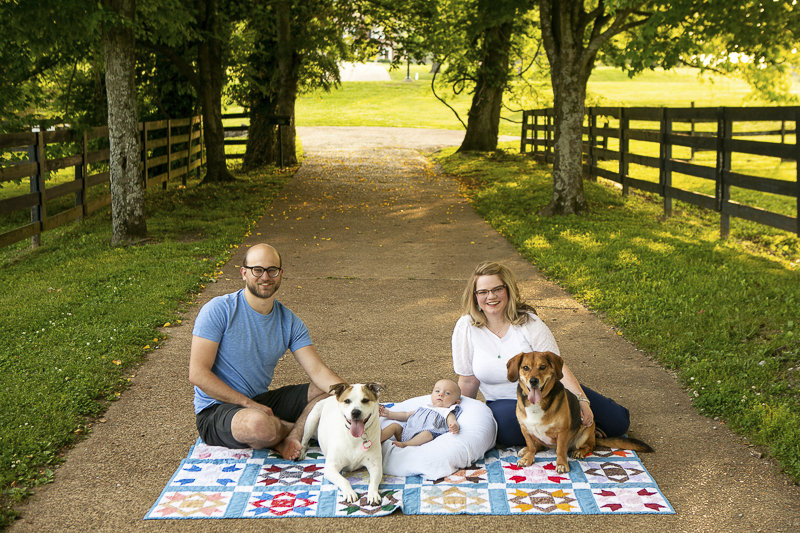 couple, baby, dogs sitting on quilt on path ©Mandy Whitley Photography | Nashville Pet and Family Photographer