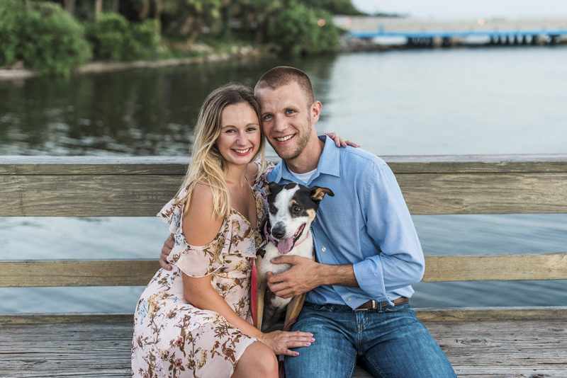 couple and their dog sitting on pier, ©Liz Cowlie Photography-dog-friendly engagement session