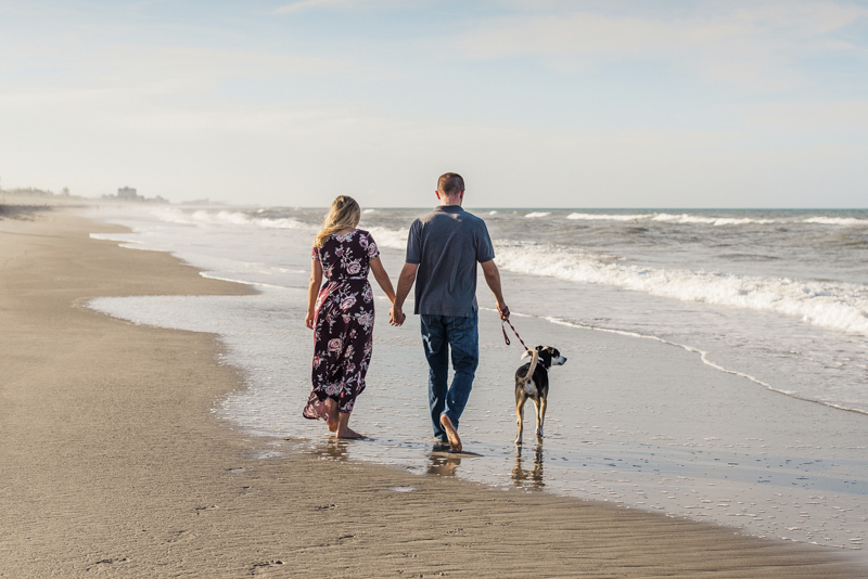 Beach engagement photos with a Collie Heeler mix, couple and their dog walking on the beach, ©Liz Cowlie Photography