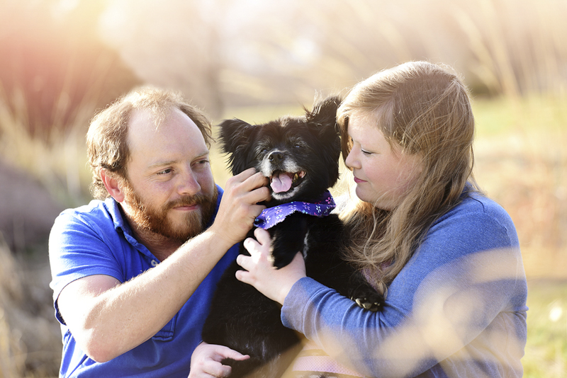 couple holding their older Pomeranian mix, love between humans and dogs, ©Wag Your Tail Photography 