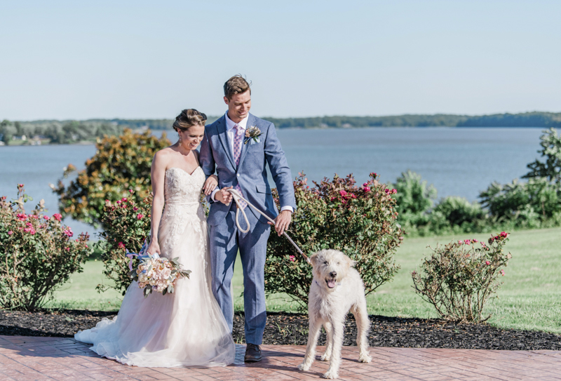 couple and dog with roses, river in background, ©Landrum Photography | dog-friendly wedding